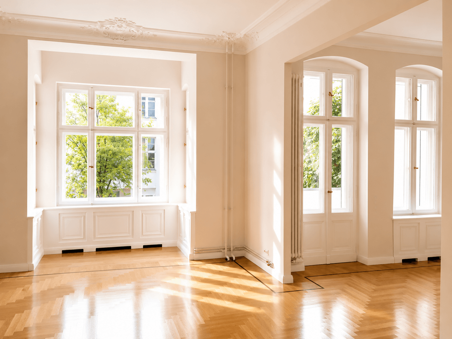 Heller Altbau-Raum mit Erkerfenster, Stuck und Fischgrätparkett